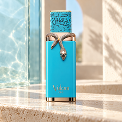 French Avenue Vulcan Feu 100 ml: Turquoise bottle with gold snake decoration on a stone ledge beside a sunlit window