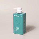 Teal bottle of Medix 5.5 skin care product on a beige background