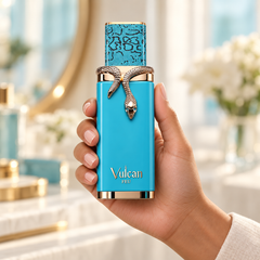 French Avenue Vulcan Feu 100 ml: Hand holding the turquoise bottle with a gold snake ornament in a sunlit interior
