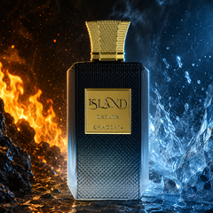 A luxury perfume bottle labeled 'ISLAND DREAMS KHADLAJ' stands centered between dramatic fire on the left and icy water on the right. The bottle has a dark textured body with a metallic gold cap and gold label, set against a split fiery-blue and orange background.